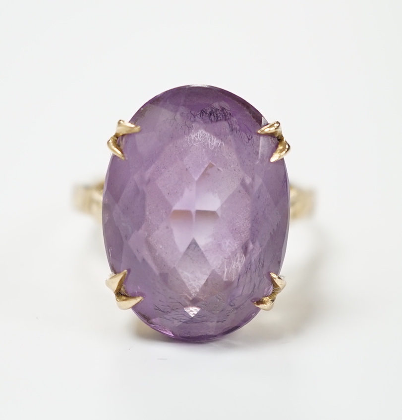 A modern 9ct gold and oval cut amethyst set dress ring, size M, gross weight 5.9 grams.